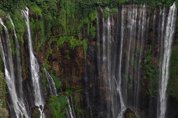 Fototapeta na wymiar Close-up view of a section of the Coban Sewu waterfall in Java, Indonesia