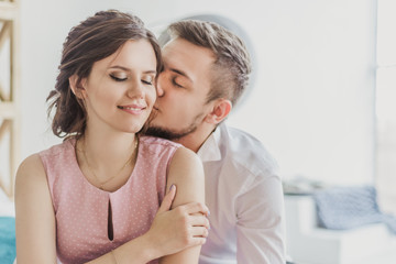 young guy kissing girl on the cheek, happy couple in love, love, Valentine's day