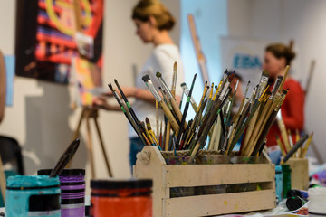 Jars of paint and brushes