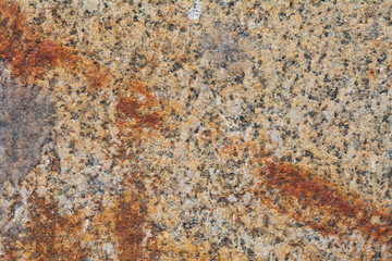 The texture ocher granite slab with a strip of rust on the diagonal