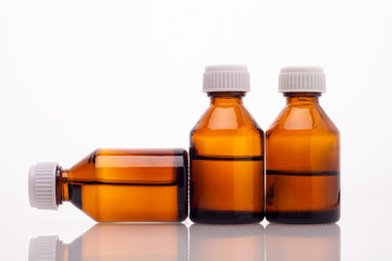 three medical phials on a white background