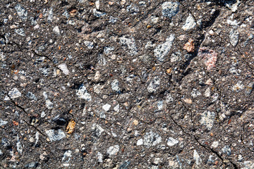 old asphalt with gravel and rubble close-up