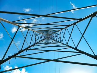 electricity pylon against blue sky