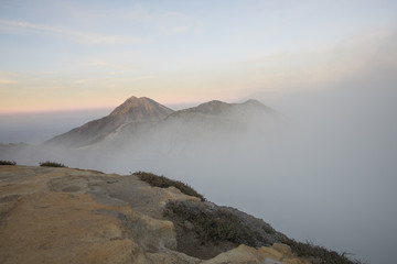 A smokey and active crater during sunrise at Mount Ijen volcano in East Java, Indonesia