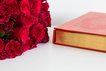 Koran and rosary beads on the white background with roses for Islamic concept. Holy book quran for Muslims holiday, Ramadan,blessed Friday message and three months.