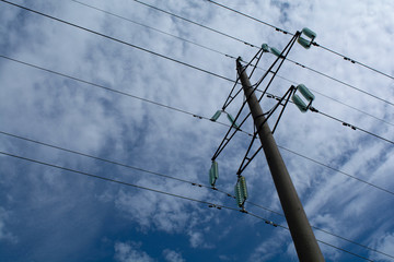 post with wires early in the morning against the sky