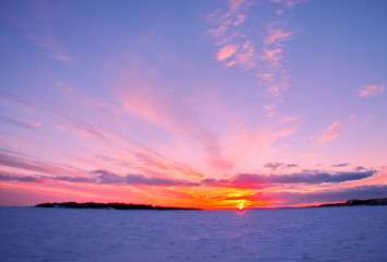 Winter sunset over frozen Baltic Sea in Finland