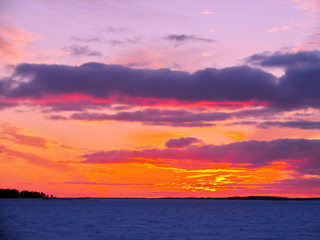 Naklejka na ściany i meble Winter sunset over frozen Baltic Sea in Finland