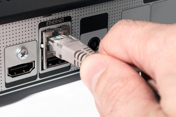 male hands insert a network cable