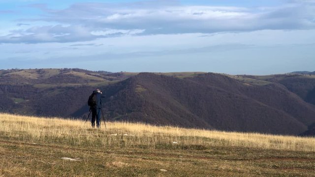 Man shooting on mountain - (4K)