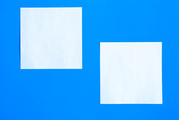 White sheets of note paper and your text on a blue background