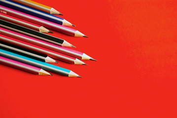 Pencils on red background