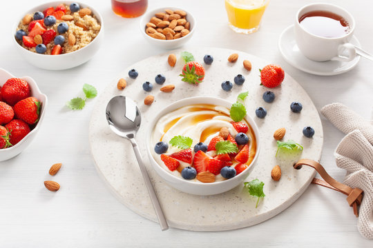 yogurt with strawberry blueberry honey almond and quinoa for breakfast