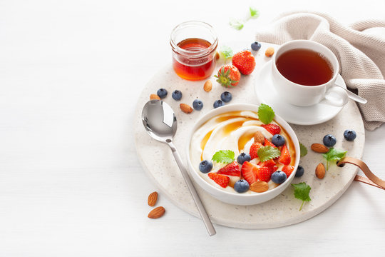 yogurt with strawberry blueberry honey almond for breakfast