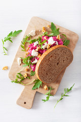 beetroot and feta cheese sandwich with walnuts and rocket