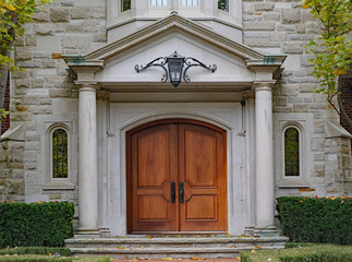 Fototapeta na wymiar elegant double front door with stone columns