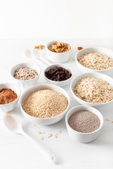 variaty of raw cereals and nuts for breakfast. Oatmeal flakes and steel cut, barley, walnut, chia, raisins. Healthy ingredients