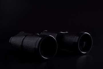 binoculars on a black background