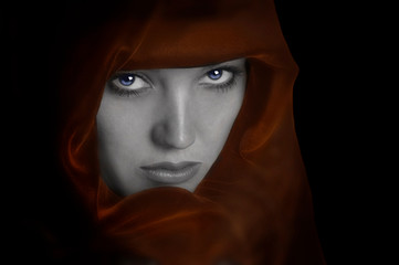 Woman on black with red cape