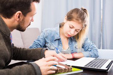Fototapeta premium Tutor helping teenage to prepare