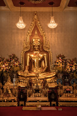 Close up indoor shiny golden buddha statue in buddhist temple in Bangkok, Thailand