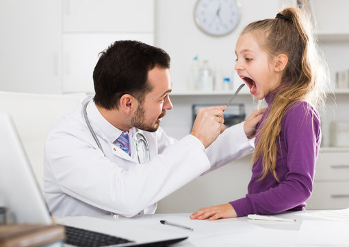 Male doctor and little girl