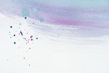 close up of abstract violet and blue watercolor painting with splatters