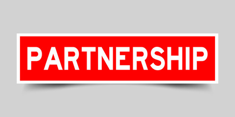 Square red sticker label in word partnership on gray background
