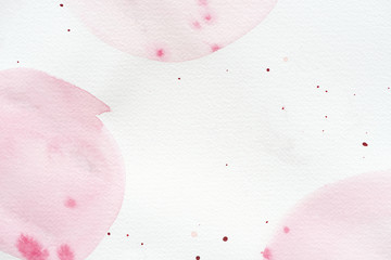 abstract background with light pink watercolor painting and splatters