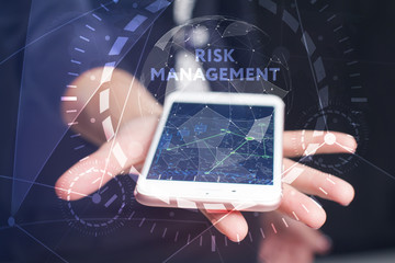 The concept of business, technology, the Internet and the network. A young entrepreneur working on a virtual screen of the future and sees the inscription: Risk management