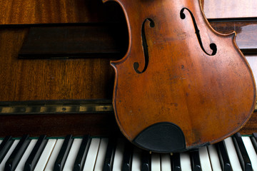 old violin on the piano