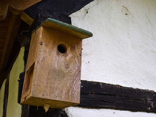 Traditional classic wooden nesting box on a house wall