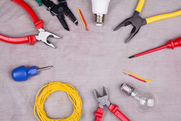 tools for an electrician on gray cloth