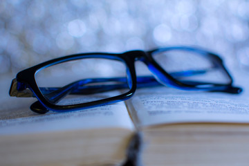 blue glasses on the book