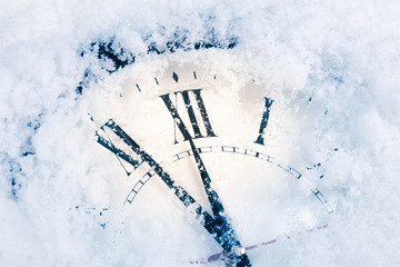 New Year's clock in the snow. Christmas card