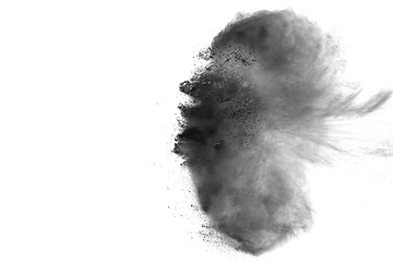 Black powder explosion against white background. Black dust particles splashing.