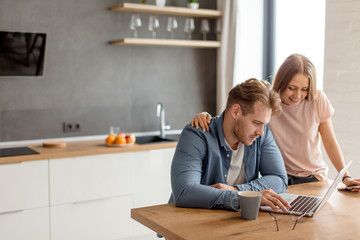 a young couple is looking a tickets for travelling. copy space. man searching a cheep travel tour...