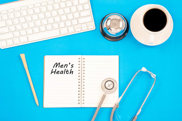 Stethoscope on notebook and pencil with men's health words as medical concept.