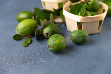 Fresh feijoa and jam on textured background