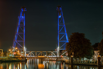 Lifting bridge illuminated by blue lights in a town near Gouda, Holland