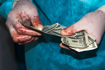 Corrupt doctor gets money. Bloody money (concept of expensive treatment)