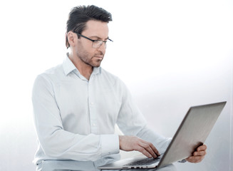 close up.serious businessman typing text on laptop