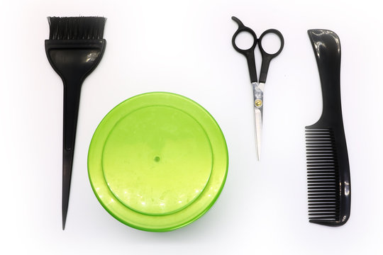 brush, scissors, comb and a capacity with hair dye, hairdresser tools on white background, isolated