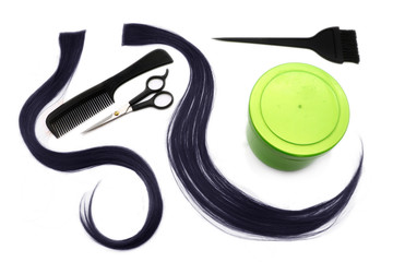 a strand of black hair, brushes, scissors, comb and container with hair dye, hairdressing tools on a white background, isolated