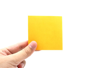 Hand holding an orange paper stick note isolated on a white background.