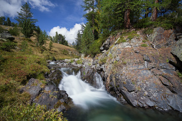 Naklejka na ściany i meble Small waterfall in the Alps mountains
