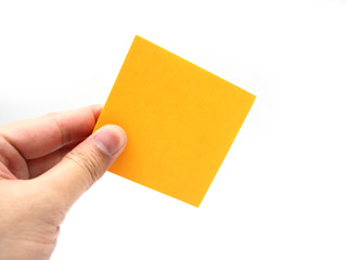 Hand holding an orange paper stick note isolated on a white background.