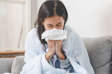 Sick day at home. Asian woman has runny and common cold. - obrazy, fototapety, plakaty