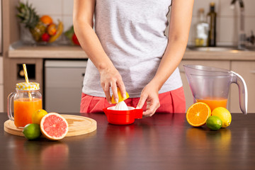 Woman using a lemon squeezer