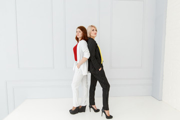 Fashion portrait of women in white and black suit